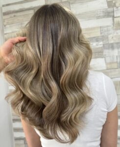 Teddy Blonde to Bronde Balayage Hair Colour on long wavy hair