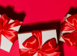 two white boxes with red bows on a red background
